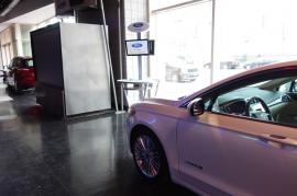 Cell Phone Charging Stations with Dual Monitors and Graphics at Auto Dealership -- Image 4