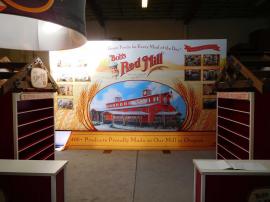 Custom Exhibit with SuperNova LED Lightbox (12 ft. H x 20 ft. W) and Product Shelving with Truss Header and Graphics