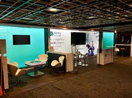 Custom Inline Exhibit with Large LED Lightboxes, Multiple Meeting Spaces, Monitor, Charging Station, and Storage