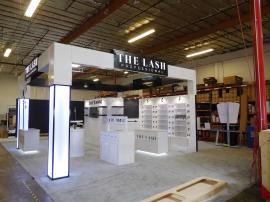 Custom Island Exhibit with Product Shelves, Cabinets, and Storage. Includes LED Accent Lighting, Full-size Closet, SuperNova Lightbox, Vinyl Graphics, and Monitor Mount