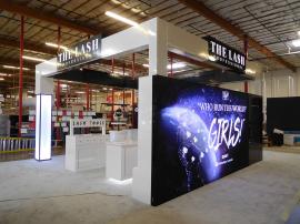 Custom Island Exhibit with Product Shelves, Cabinets, and Storage. Includes LED Accent Lighting, Full-size Closet, SuperNova Lightbox, Vinyl Graphics, and Monitor Mount