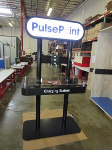 Custom Charging Station with Double-sided Backlit Graphics, Plex Counter Top, and Wireless and Wired Charging Options