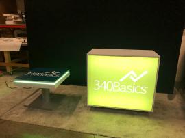 RENTAL: RE-1584 Backlit Counter, RE-713 Charging Station Table, SEG Fabric Graphic, and Vinyl Applied Top Surface Graphic